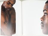 an open book with a picture of a man with a tattoo on his chest