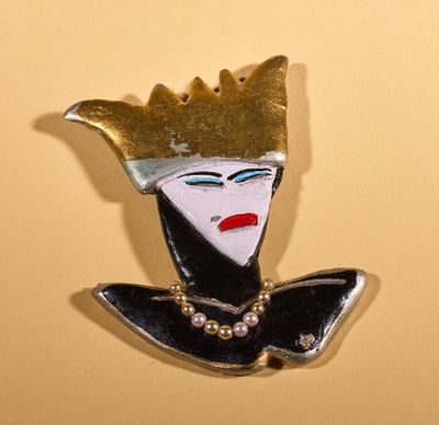 a picture of a pin with a woman ' s face on it