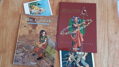 two books on a wooden table with a picture of a man and a woman