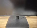the monitor is sitting on a desk with a mouse on it