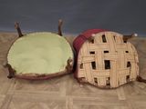 two baskets that are sitting on a wooden floor