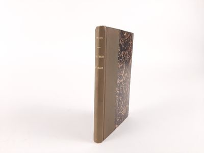 an old book with a brown cover sitting on top of a white surface