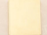 yellow gold plated square shaped box on a beige background