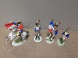 five figurines of soldiers riding horses on a table