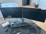 two computer monitors and a keyboard on a desk