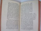 an open book on a white table with a red border