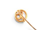 a gold brooch with a knot on it on a white surface