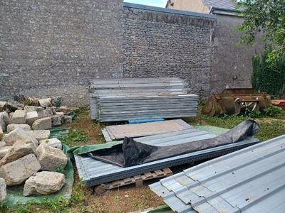 a pile of rocks and a pile of metal on the ground