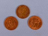 three different types of coins are shown on a white surface