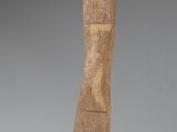 wooden sculpture of a curved body on a black base