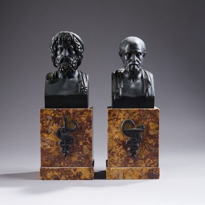 a pair of bronze busts of a man and a woman