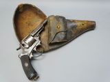 a close up of a revolver with a leather case on a table