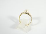 a close up of a gold ring with a pearl on it