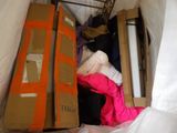 a pile of clothes in a cardboard box in a room