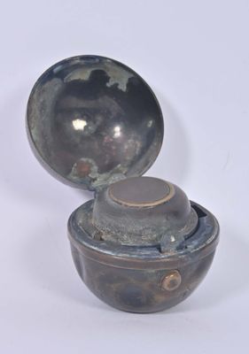 a small bowl with a lid on a white surface