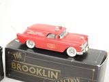 a red toy car sitting on top of a black box