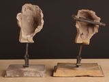 two sculptures that are sitting on a wooden table