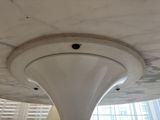 a white marble ceiling with a white ceiling fan in it