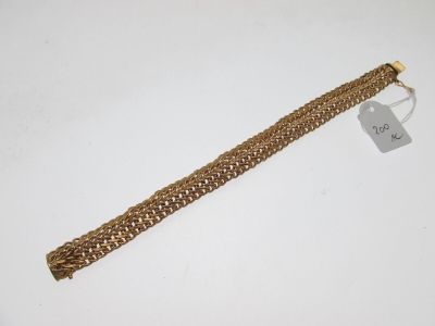 Gros plan sur un bracelet en or portant une étiquette