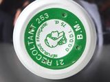 a close up of a green and white cup with a green lid