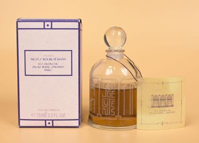an image of a bottle of perfume next to a box of perfume
