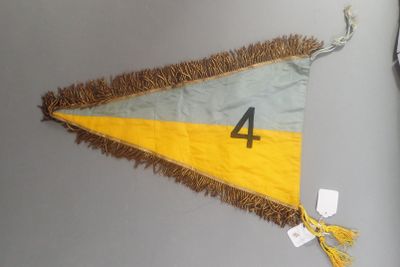 a yellow and gray pennant with a number 4 on it