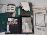 a lot of old papers and stamps on a table