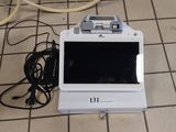 a laptop computer sitting on the floor next to a bicycle