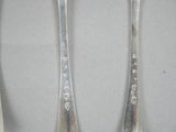 two spoons and a fork sitting on a table