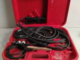 a red tool box with a hose and other tools in it