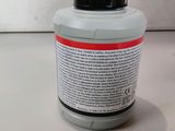 a close up of a bottle of liquid on a table