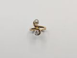 a gold ring with a pearl and a diamond