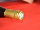 a bottle of wine sitting on a red table cloth