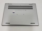 the back of a silver laptop computer sitting on top of a white table