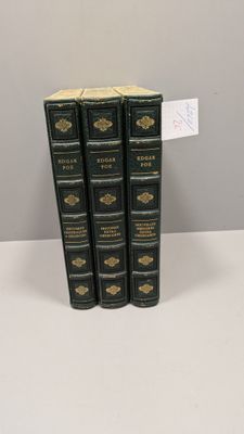 three books are stacked on top of each other on a table