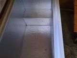 a small metal sink in the corner of a room