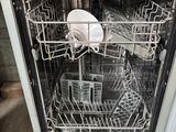 a dishwasher with a lot of dishes inside of it