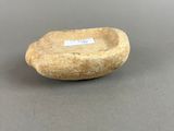 a close up of a small stone bowl on a table