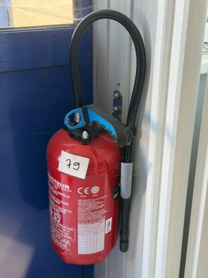 a red fire extinguisor attached to a blue door