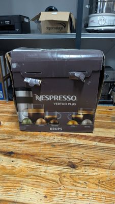 a box of nespresso vertuo plus coffee on a wooden table