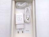 a white box with a charger and a cord in it