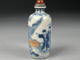 a blue and white snuff bottle with a picture on it