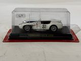 a close up of a car in a glass case on a white surface