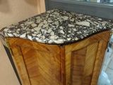 a wooden cabinet with a marble top in a room
