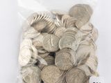 a bag full of silver coins on a white surface