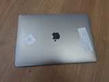 an apple macbook pro laptop sitting on top of a wooden table