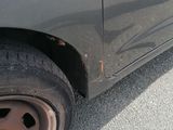a car that has a flat tire on the side of the road