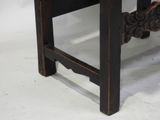 a wooden bench with a carved design on it