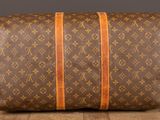 a brown and orange louis vuittou bag sitting on top of a wooden table