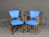 pair of blue chairs against a gray background
